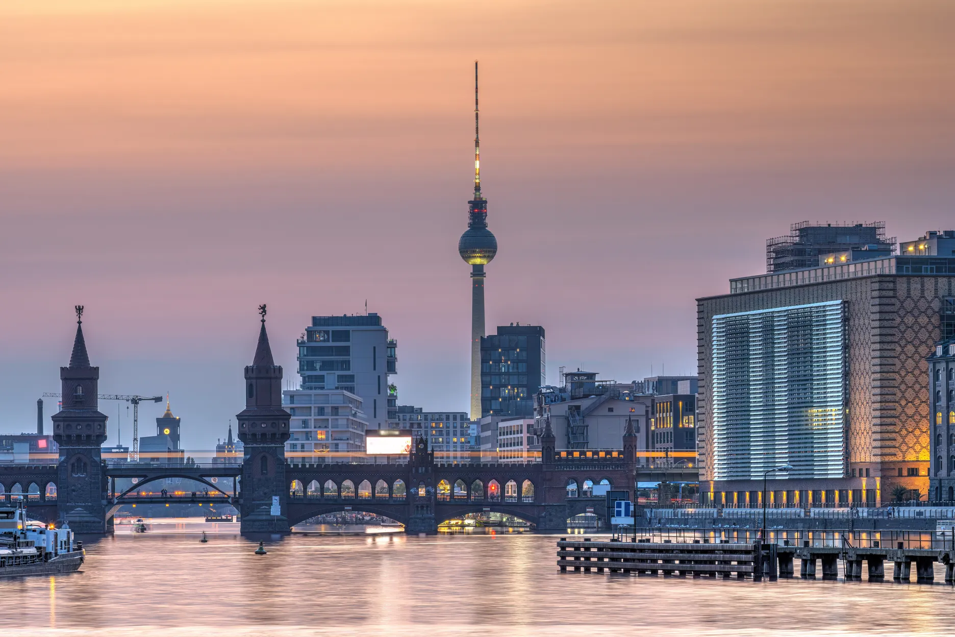 Berlin skyline at sunset featuring the TV Tower and Oberbaum Bridge, representing the European pharma AI talent market